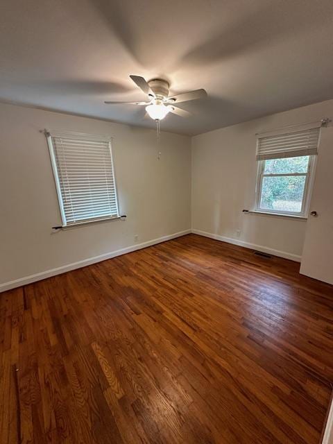 unfurnished room with ceiling fan and dark hardwood / wood-style flooring