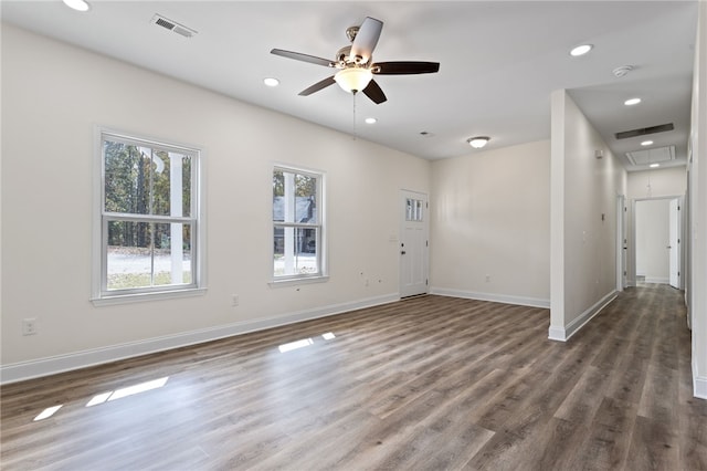 interior space with recessed lighting, visible vents, attic access, wood finished floors, and baseboards