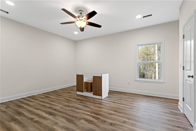 empty room with a ceiling fan, baseboards, wood finished floors, and recessed lighting