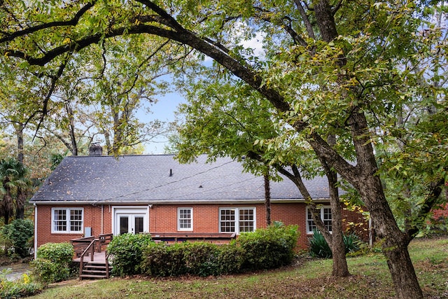 rear view of property with a wooden deck