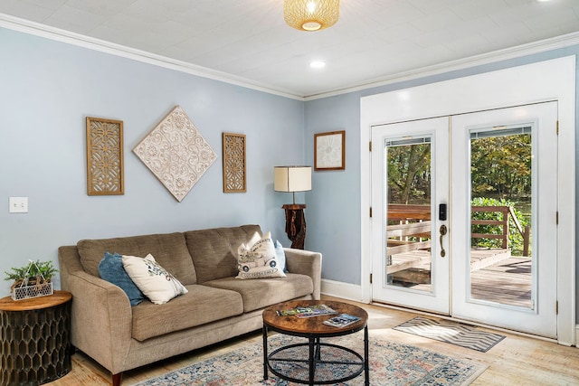 living room with crown molding, light hardwood / wood-style flooring, and french doors