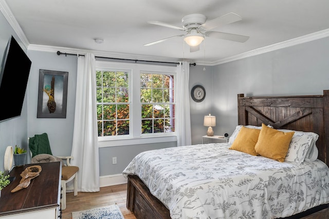 bedroom with ornamental molding, hardwood / wood-style flooring, and ceiling fan