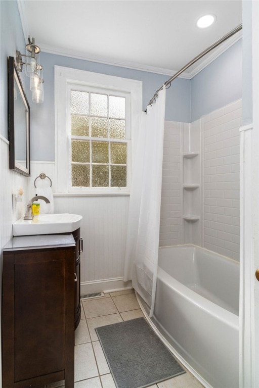 bathroom with vanity, shower / bath combination with curtain, ornamental molding, and tile patterned floors