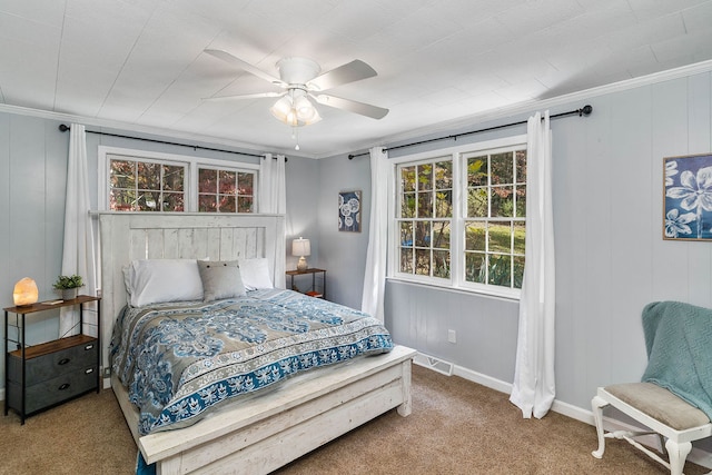 bedroom with multiple windows, carpet floors, crown molding, and ceiling fan