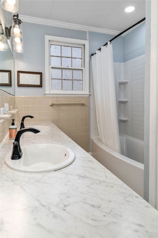 bathroom featuring vanity, shower / tub combo with curtain, crown molding, and tile walls