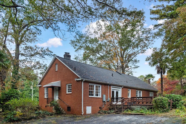 rear view of property featuring a deck