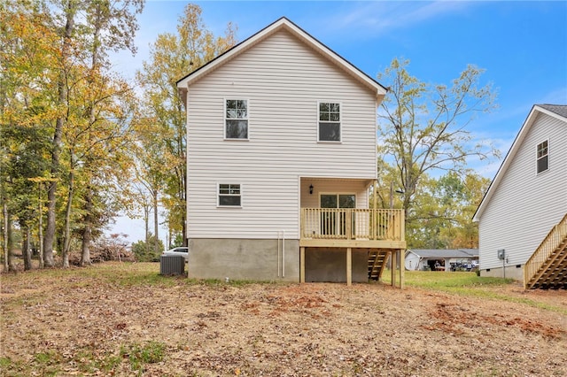 rear view of house with cooling unit and a deck