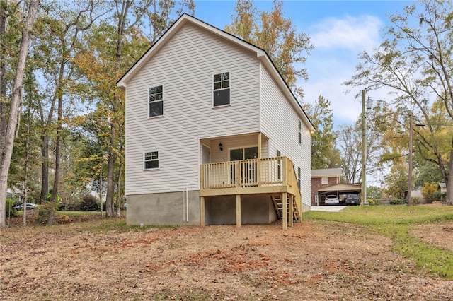 rear view of property featuring a wooden deck