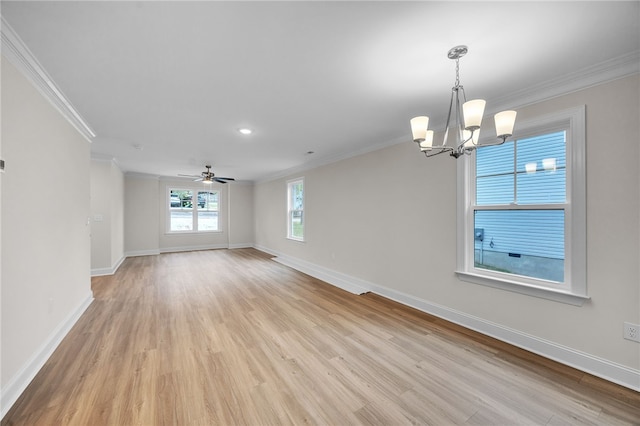 empty room featuring light hardwood / wood-style floors, ornamental molding, and ceiling fan with notable chandelier