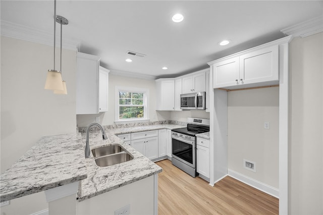 kitchen featuring sink, light wood-type flooring, stainless steel appliances, pendant lighting, and white cabinets