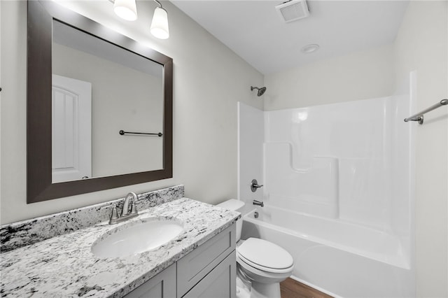 full bathroom with vanity, toilet, hardwood / wood-style flooring, and  shower combination