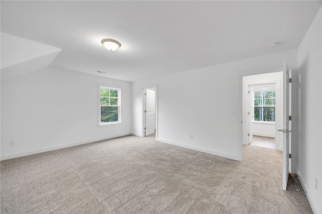 interior space featuring lofted ceiling and light colored carpet