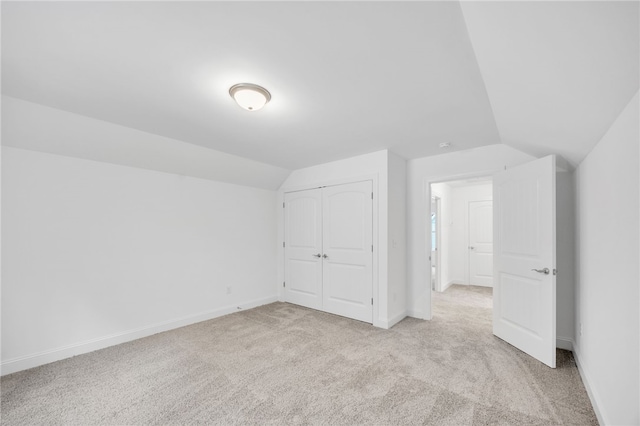 additional living space with lofted ceiling and light colored carpet