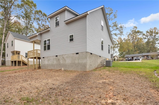 back of house with a deck and central AC unit