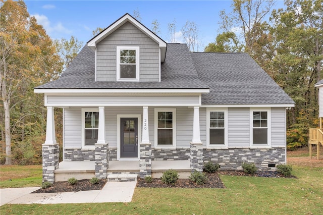 view of front facade with a porch and a front lawn