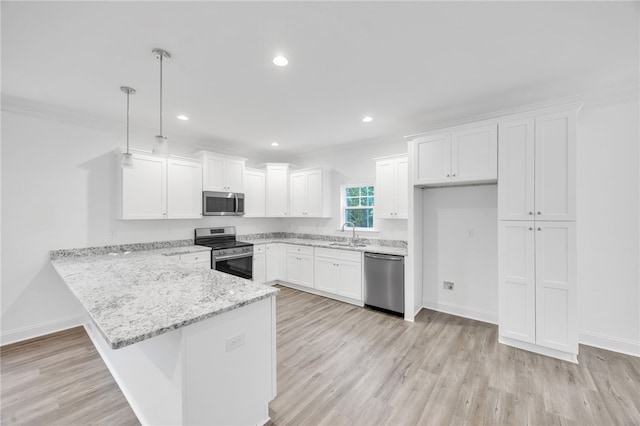 kitchen with appliances with stainless steel finishes, white cabinetry, light hardwood / wood-style flooring, sink, and decorative light fixtures