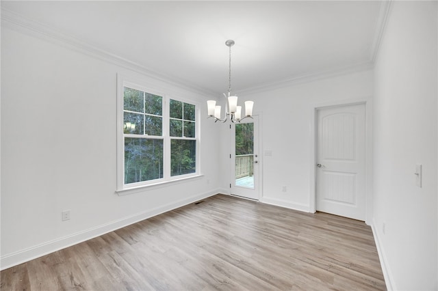 unfurnished dining area featuring crown molding, light hardwood / wood-style flooring, and a chandelier