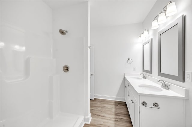 bathroom featuring vanity, hardwood / wood-style floors, and a shower