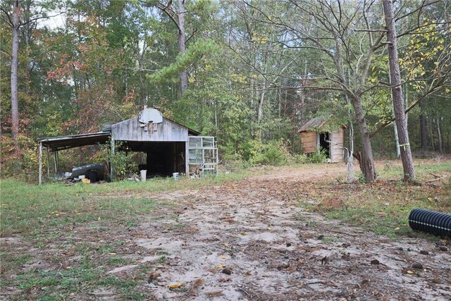 1305 Wilton E Hall Rd, Starr, SC 29684 - view of yard with an outbuilding, a view of trees, and a carport