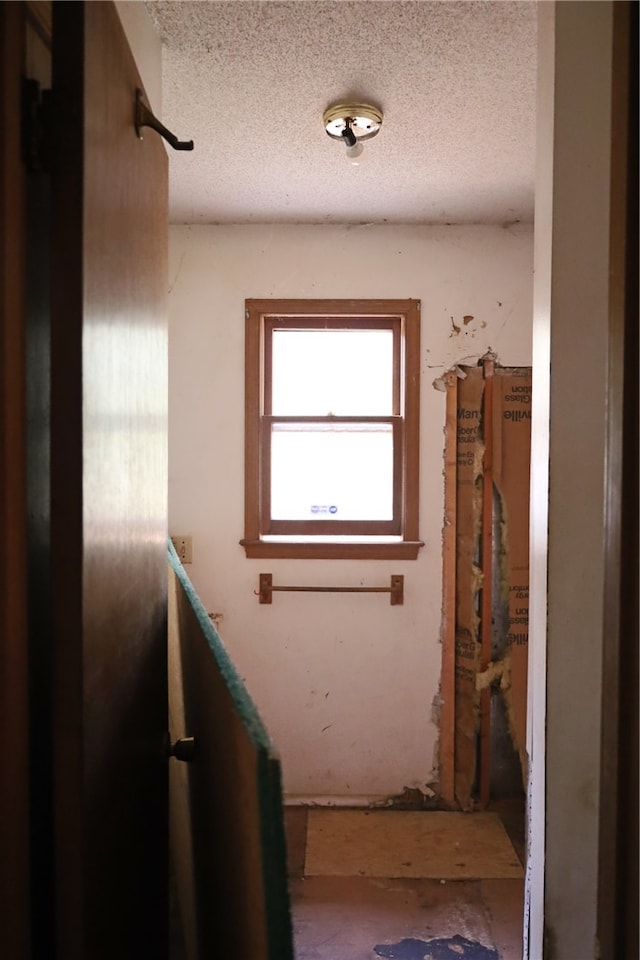 corridor with a textured ceiling