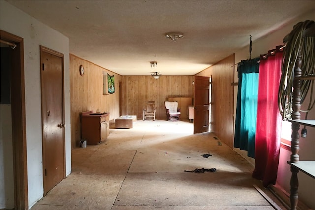 miscellaneous room featuring wood walls