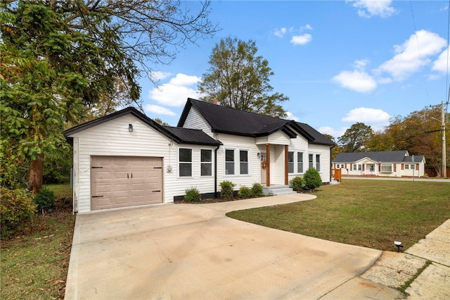 view of front of house with a garage and a front yard