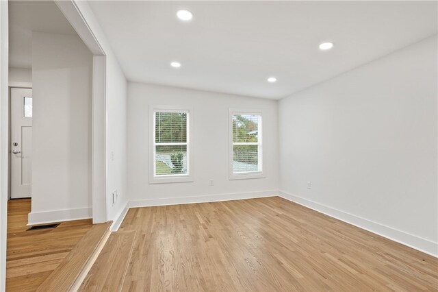 spare room with recessed lighting, visible vents, light wood-style flooring, and baseboards