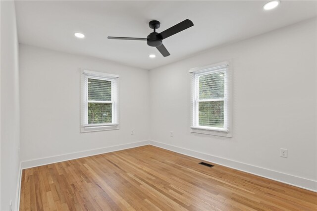 unfurnished room featuring light wood-type flooring, visible vents, baseboards, and recessed lighting