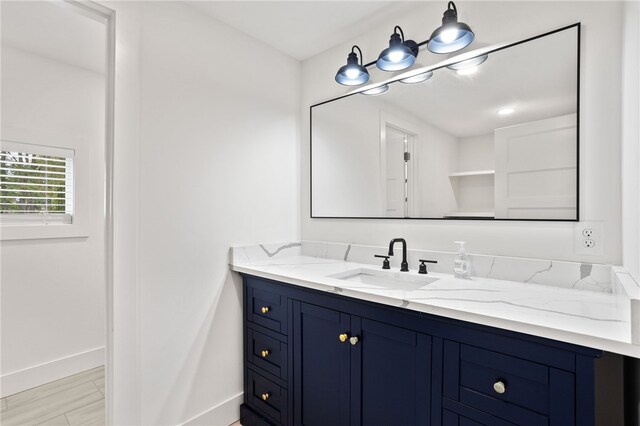 bathroom featuring vanity and baseboards