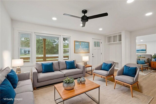 living area with a ceiling fan, recessed lighting, and light wood-type flooring