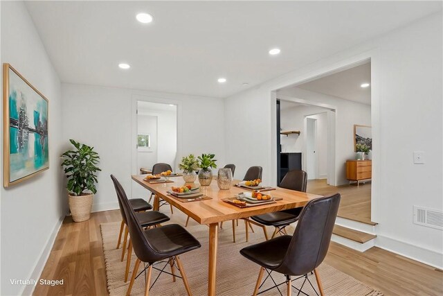 dining room with light wood finished floors, visible vents, and recessed lighting