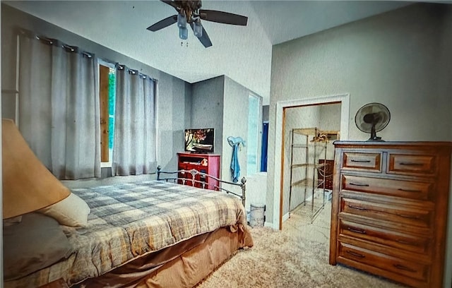 carpeted bedroom featuring lofted ceiling and ceiling fan