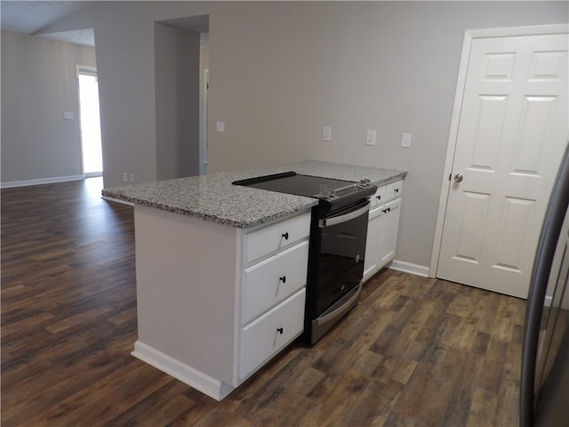 kitchen featuring dark wood-type flooring, light stone countertops, stainless steel range with electric stovetop, and white cabinets