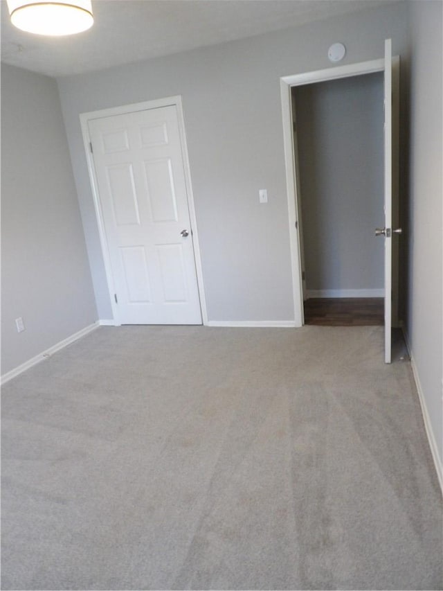 unfurnished bedroom with carpet floors and baseboards