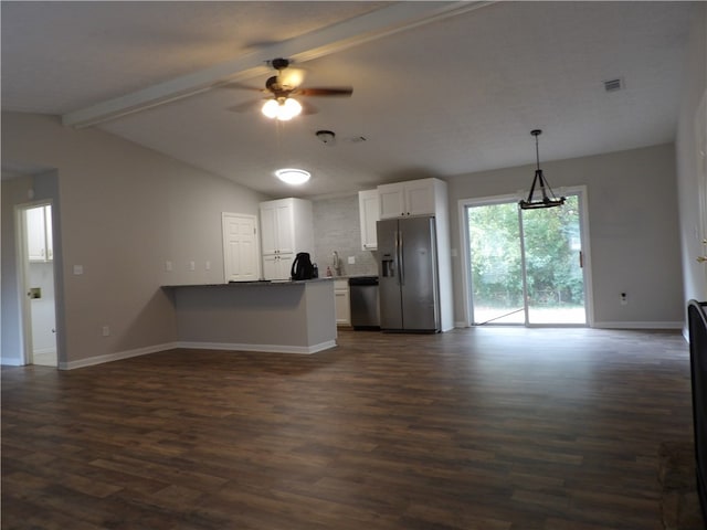 kitchen with kitchen peninsula, appliances with stainless steel finishes, dark hardwood / wood-style floors, vaulted ceiling with beams, and white cabinets