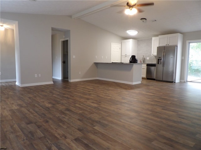 kitchen featuring stainless steel appliances, dark hardwood / wood-style floors, white cabinetry, and lofted ceiling with beams