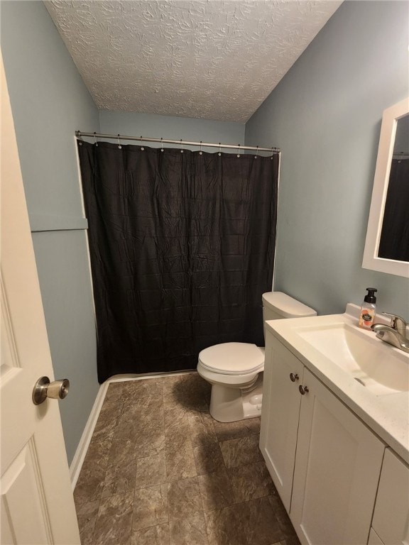 bathroom with vanity, a textured ceiling, toilet, and a shower with shower curtain