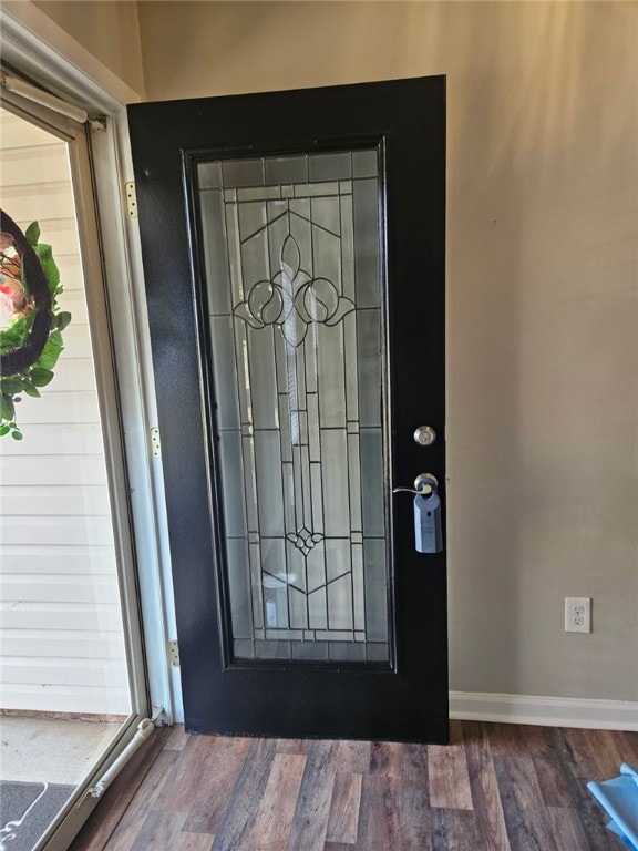 entryway featuring wood finished floors and baseboards