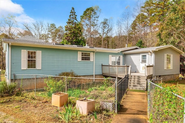 view of front of house featuring a garden, fence, and a wooden deck