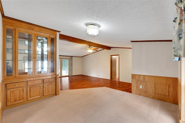 unfurnished living room with a textured ceiling, light hardwood / wood-style floors, ceiling fan, and ornamental molding