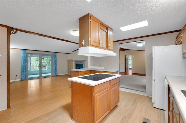 kitchen with a center island, light hardwood / wood-style flooring, vaulted ceiling, a textured ceiling, and electric stovetop