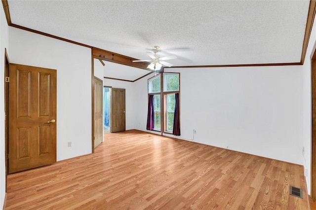 unfurnished bedroom featuring lofted ceiling, light wood-style floors, visible vents, and ornamental molding