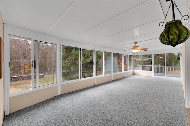 unfurnished sunroom with ceiling fan