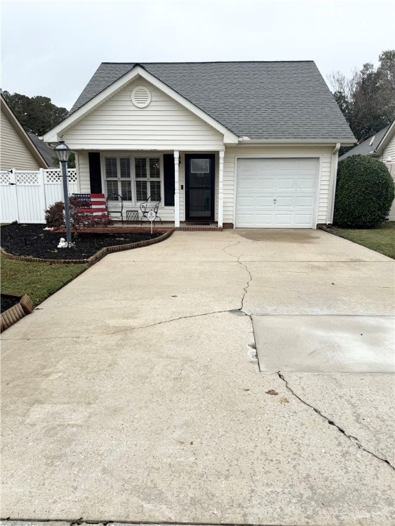 ranch-style home with a garage and a porch