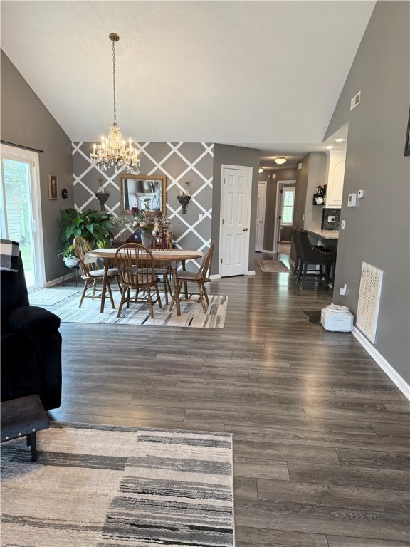 dining space with high vaulted ceiling, an inviting chandelier, and dark hardwood / wood-style flooring