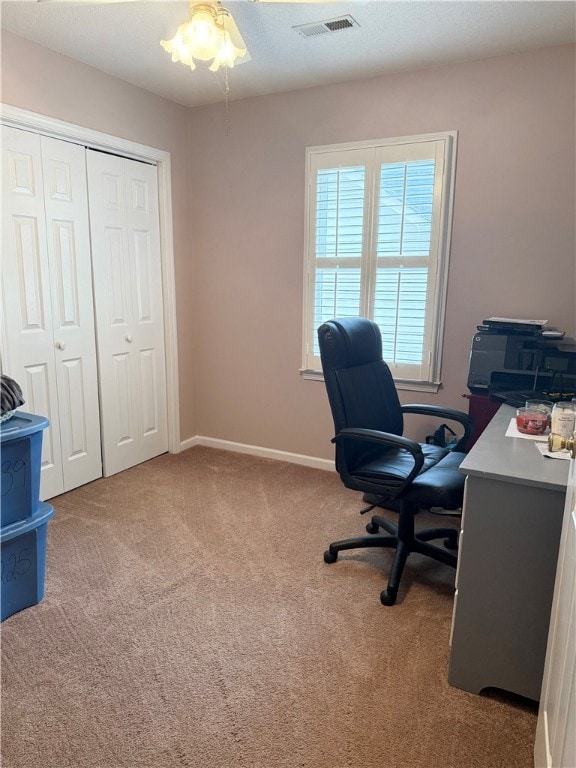 carpeted home office with ceiling fan