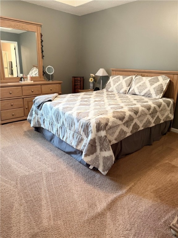 bedroom featuring carpet floors and a textured ceiling