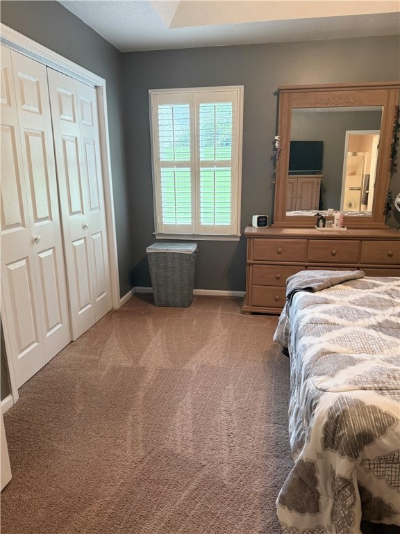 bedroom with light carpet and a closet