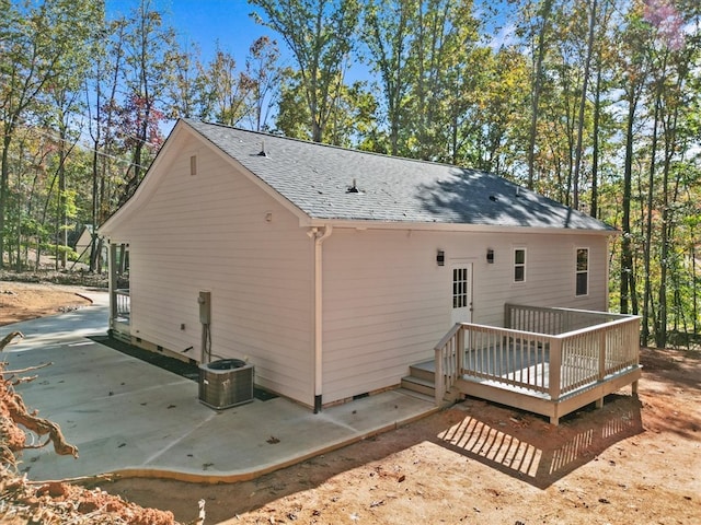 back of house featuring a wooden deck and a patio area