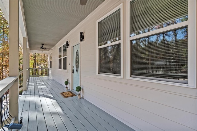 deck featuring covered porch and ceiling fan